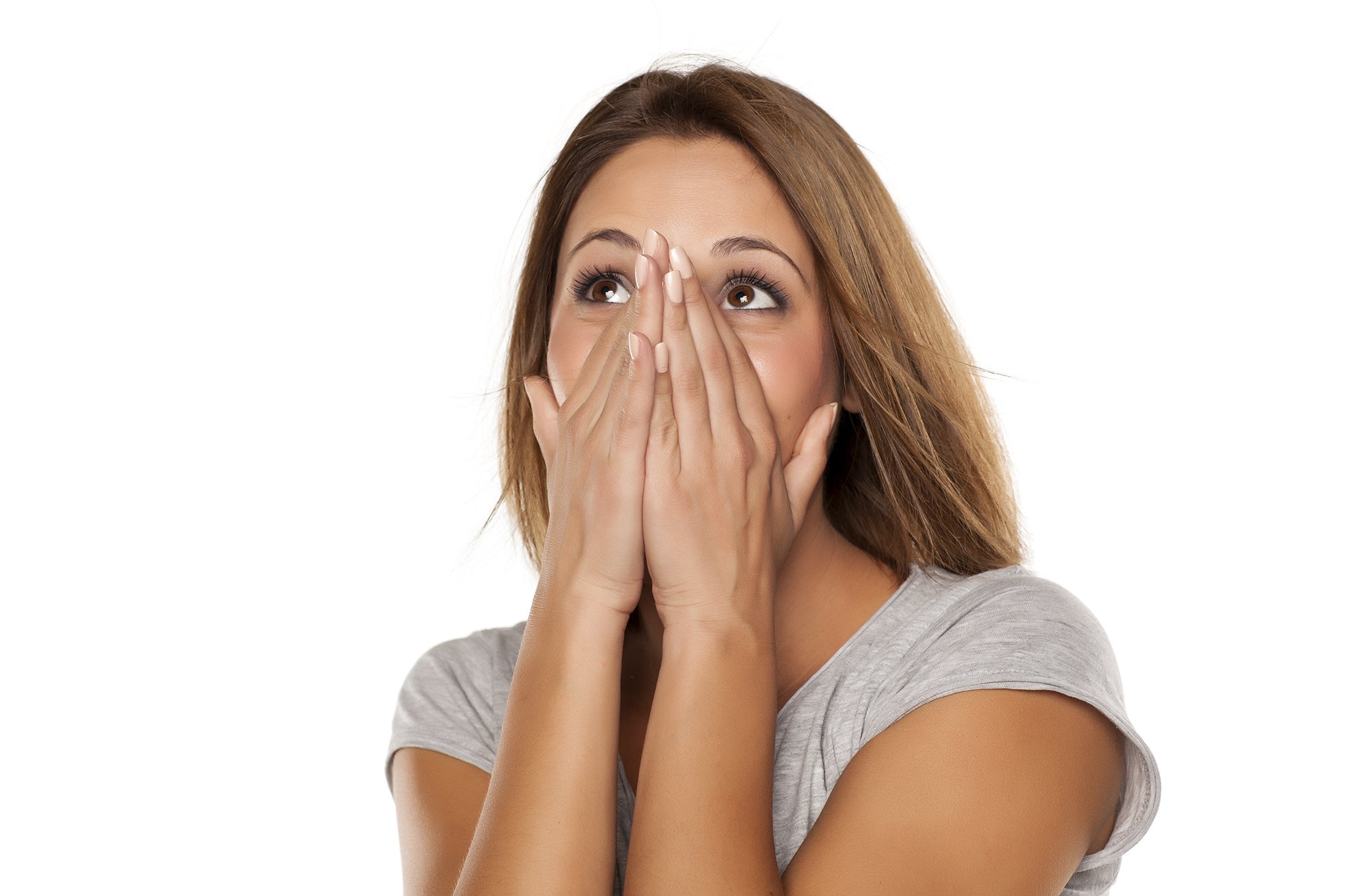 Young woman female covers her face with her hands white background