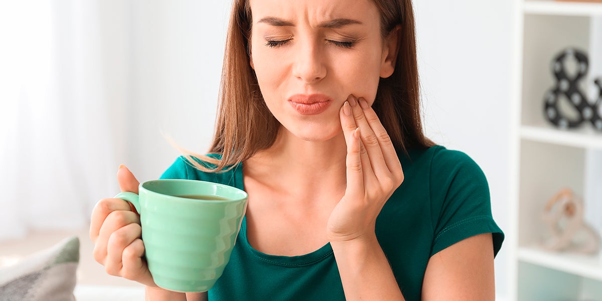 Woman drinking hot sensible teeth hypersensitivity sensivital