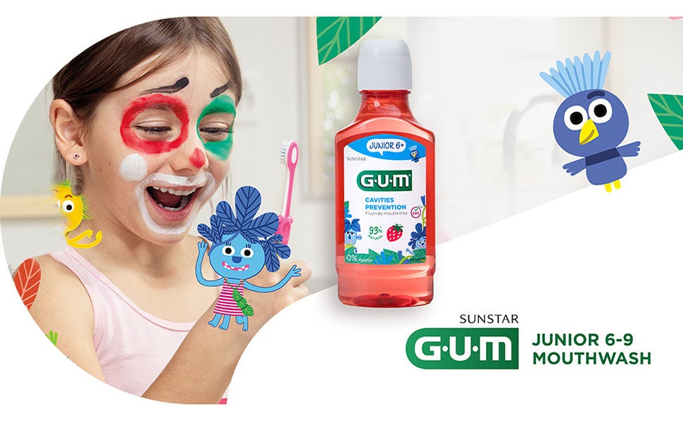 Smiling girl is handling the GUM KIDS Toothbrush and GUM JUNIOR Mouthwash standing up