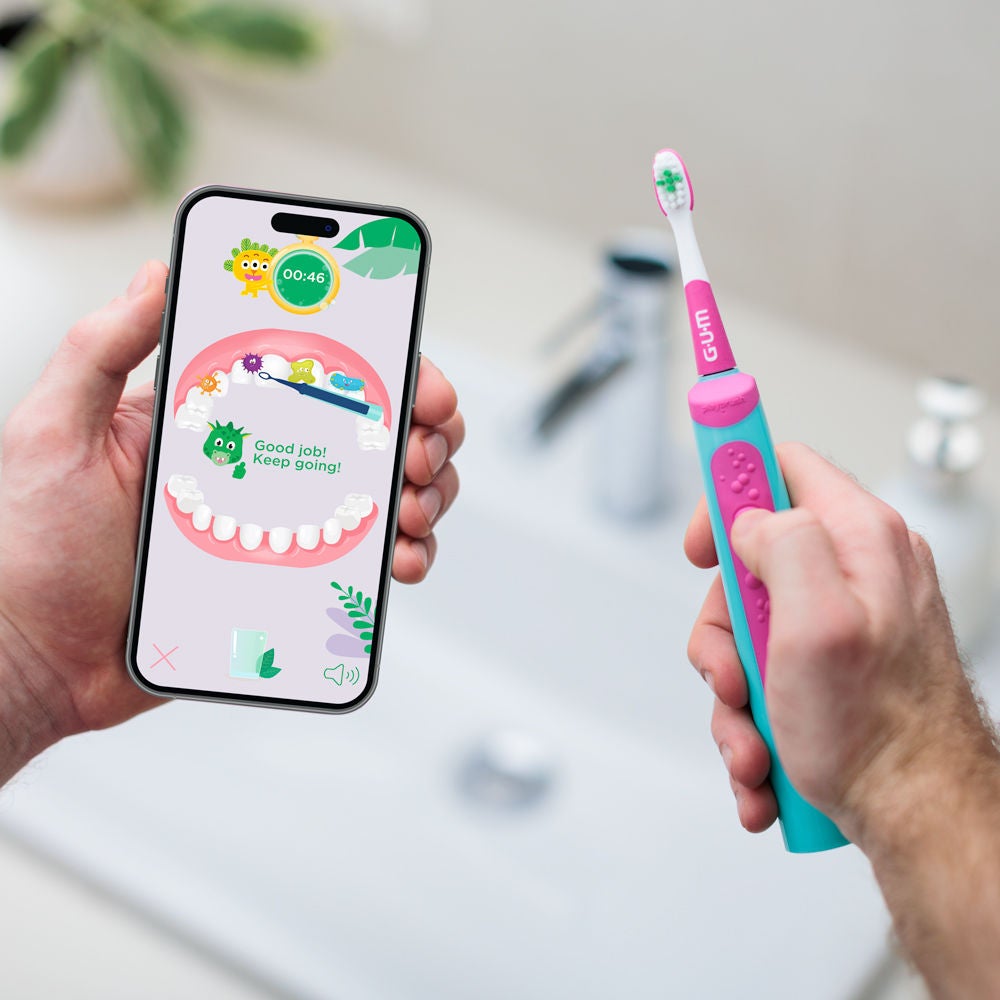 GUM Playbrush KIDS in pink colour connected to the the app