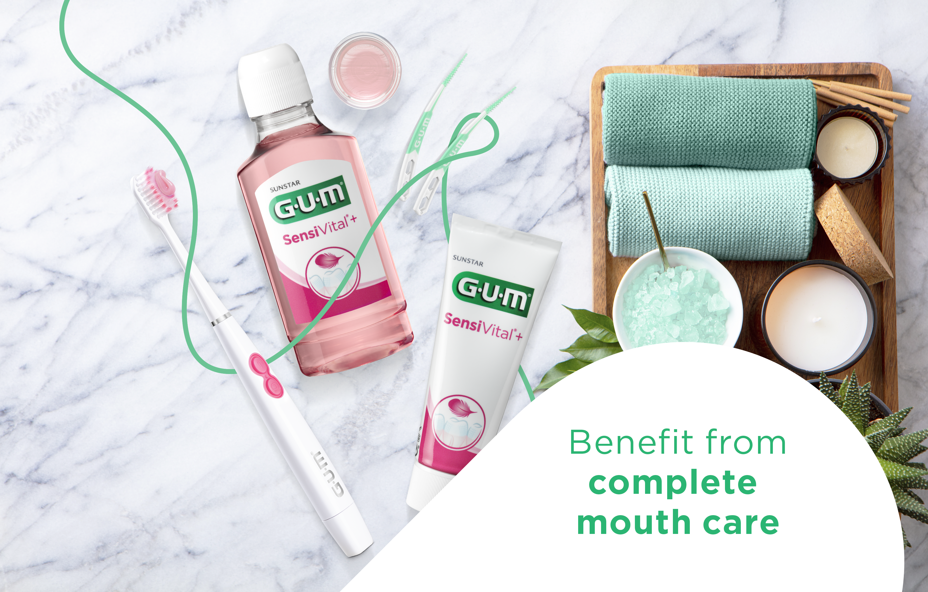 GUM CLASSIC Toothbrush, GUM BIO Toothpaste and Mouthwash, GUM SOFT-PICKS PRO Interdental Brushes in a small glass