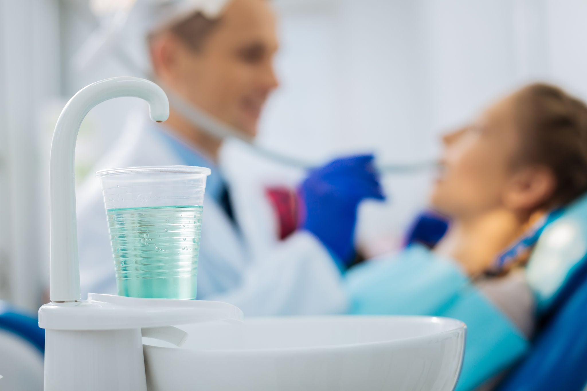 Strong disinfect. Selective focus of a glass with the mouthwash being ready to be used for disinfection