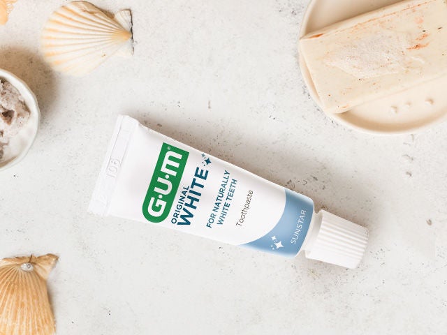GUM ORIGINAL White toothpaste in a natural environment with shells and soap 