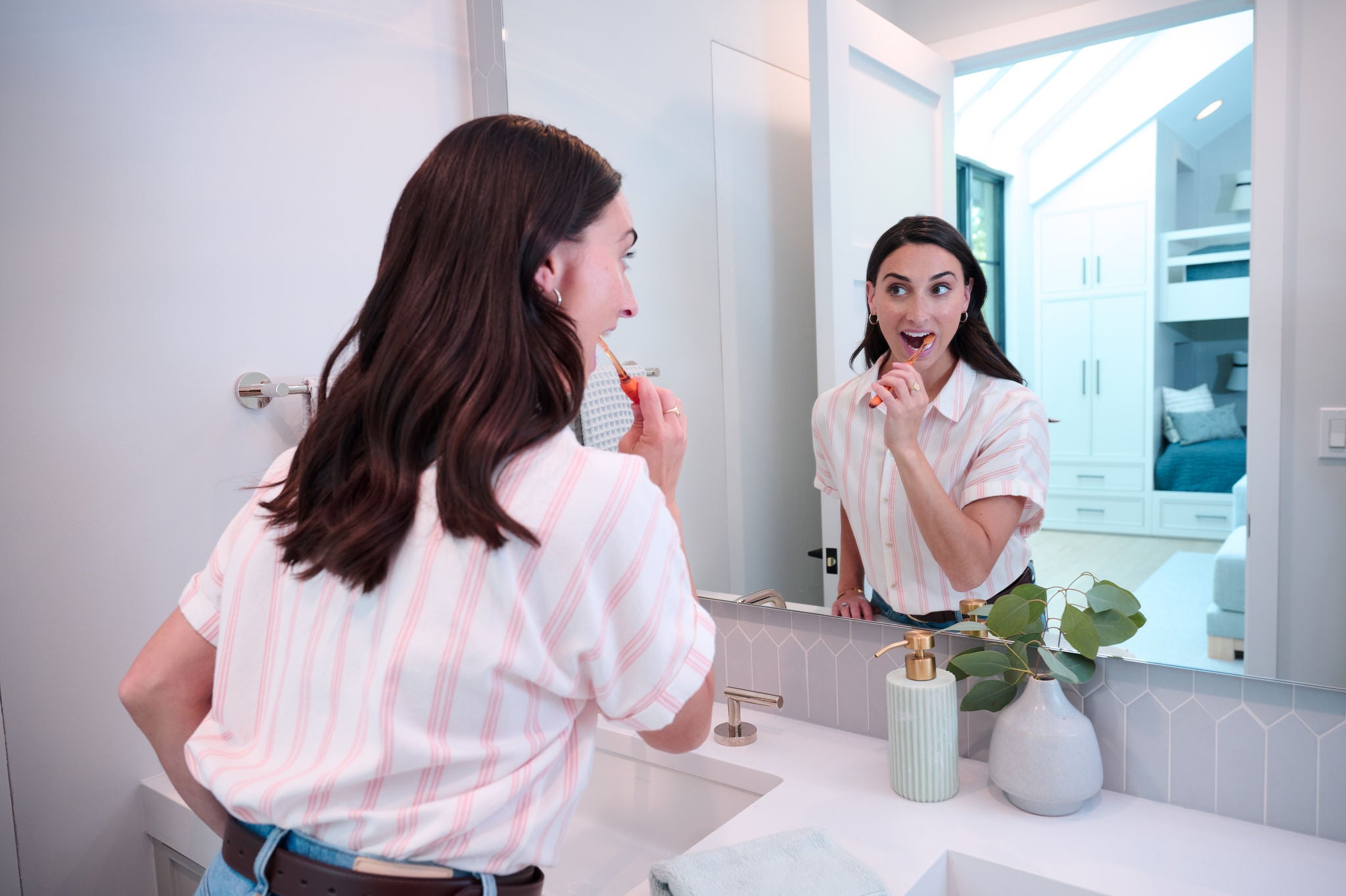 Woman is cleaning between her teeth with the GUM TRAV-LER Interdental brush