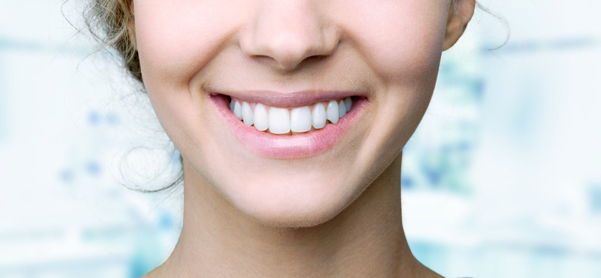 Beautiful wide smile of young fresh woman with great healthy white teeth. Isolated over background