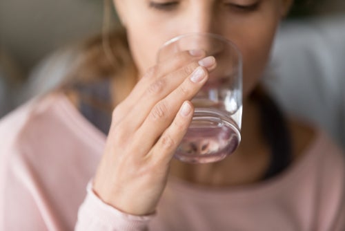 Woman drinking water from the glass