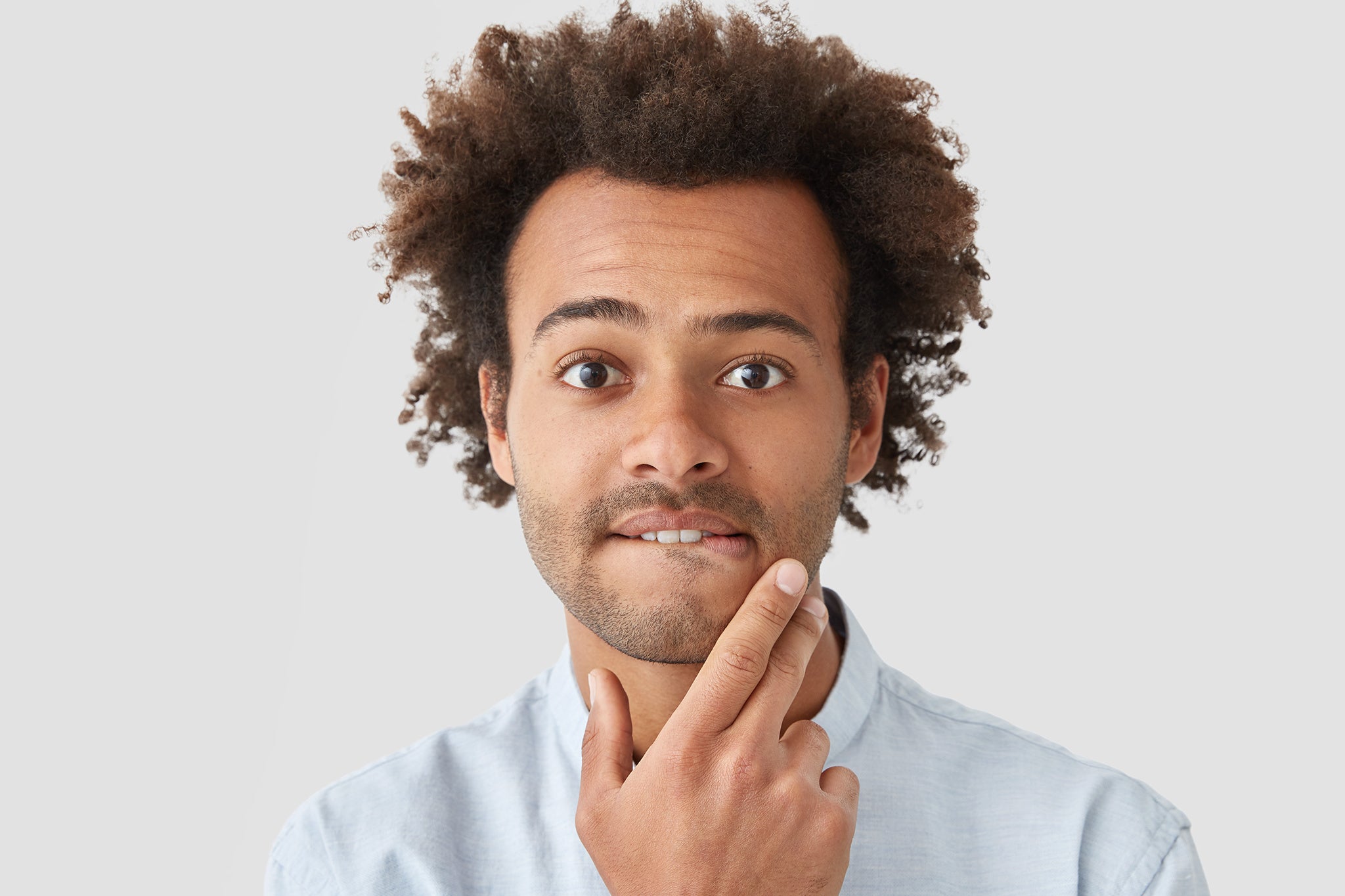 Clurly hair male man hand in face white background