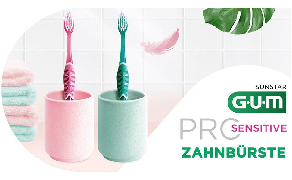 GUM PRO Toothbrushes in their glasses with soem details such as towels, feather and leaf