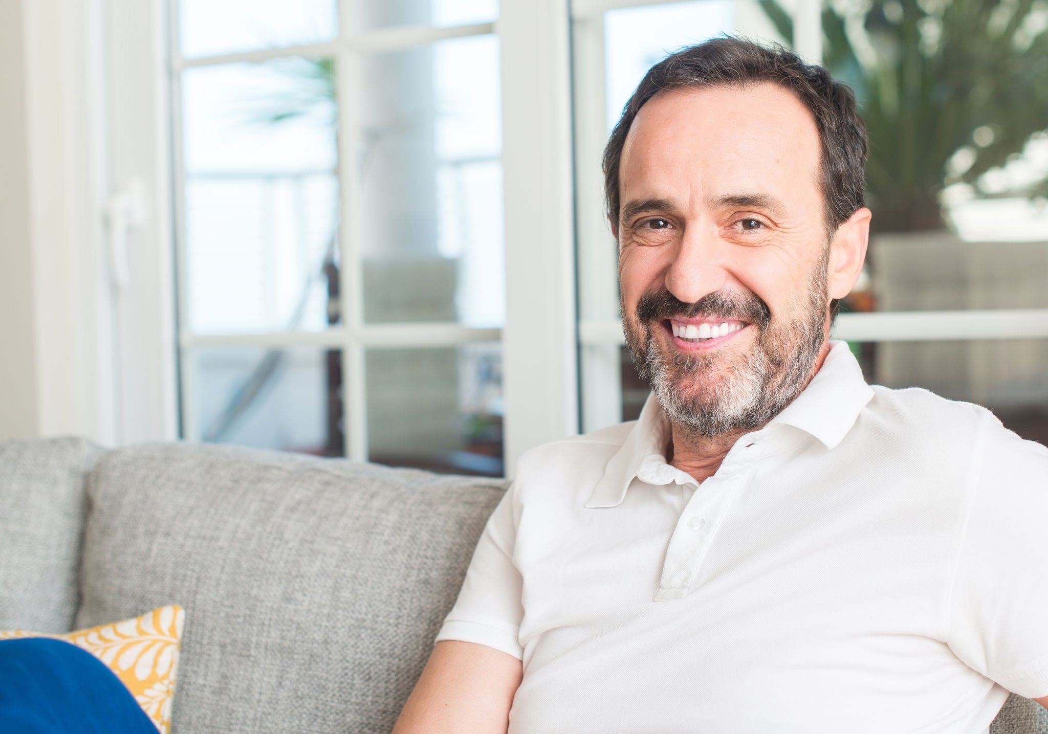 Handsome middle age man with a happy face standing and smiling with a confident smile showing teeth