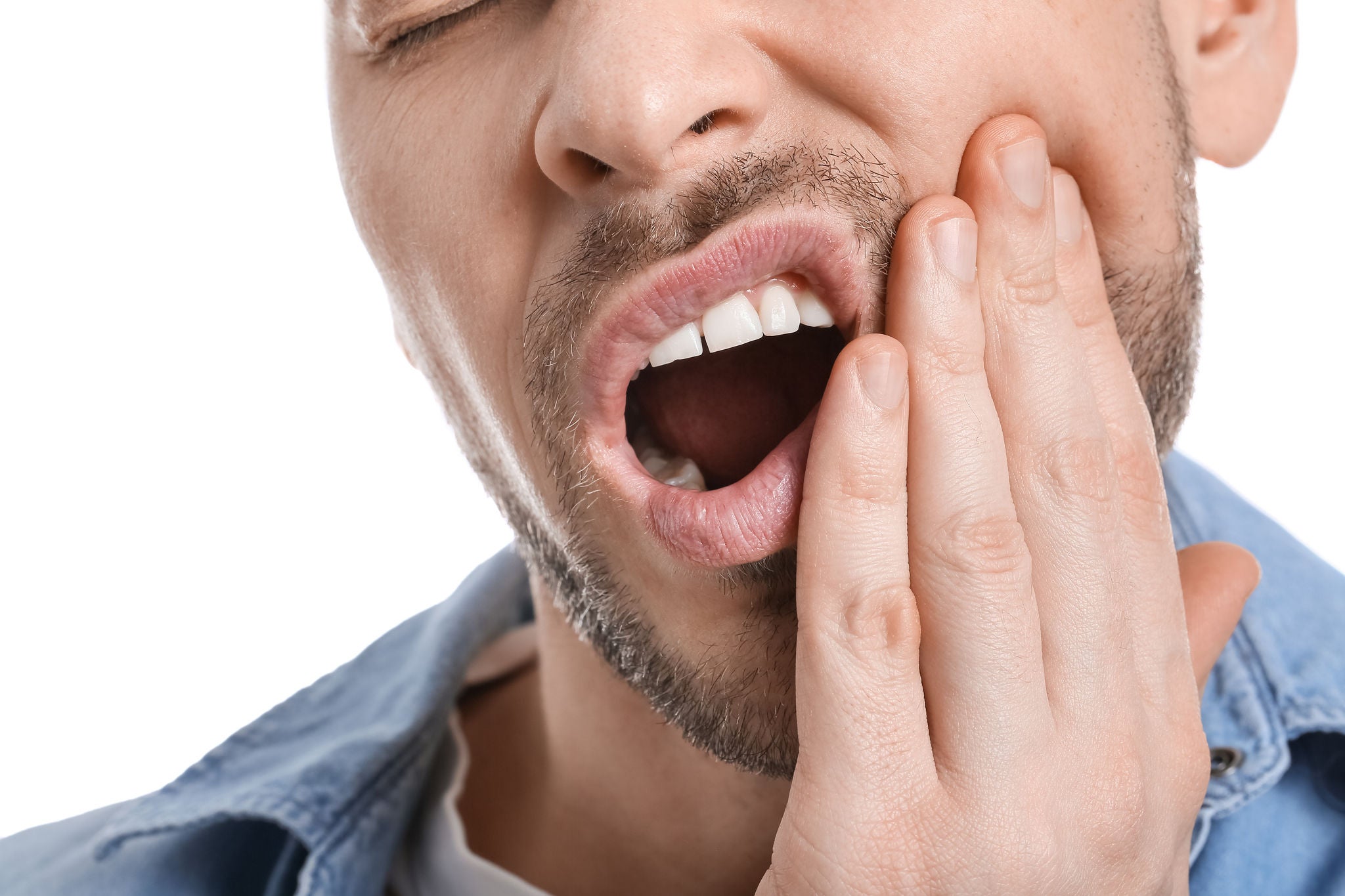 Man suffering from tooth ache on white background, closeup