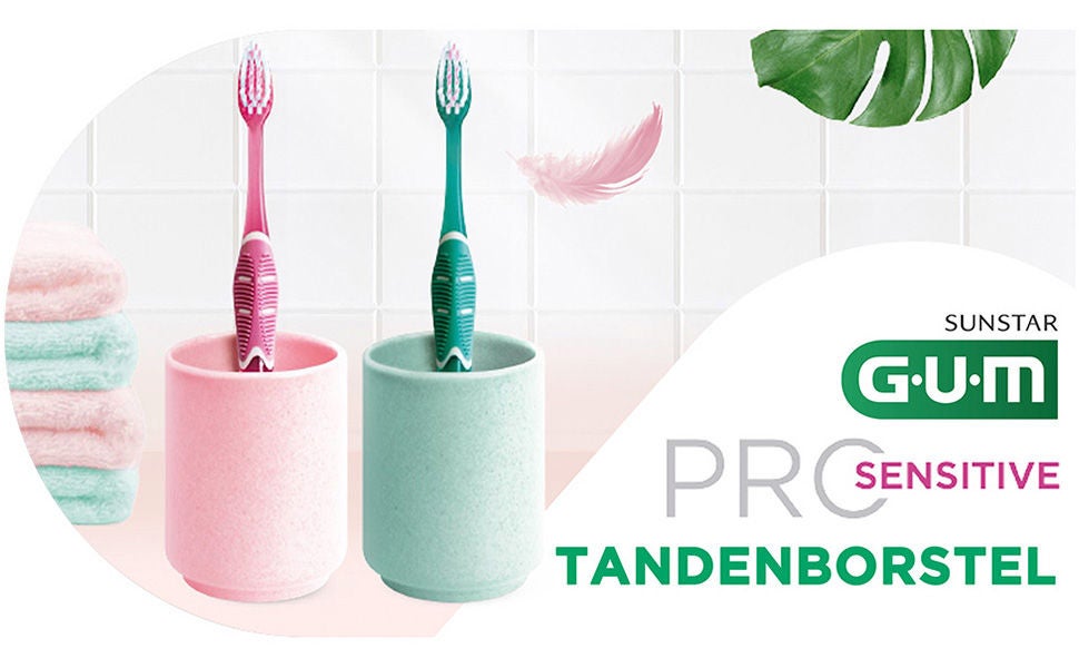 GUM PRO Toothbrushes in their glasses with soem details such as towels, feather and leaf
