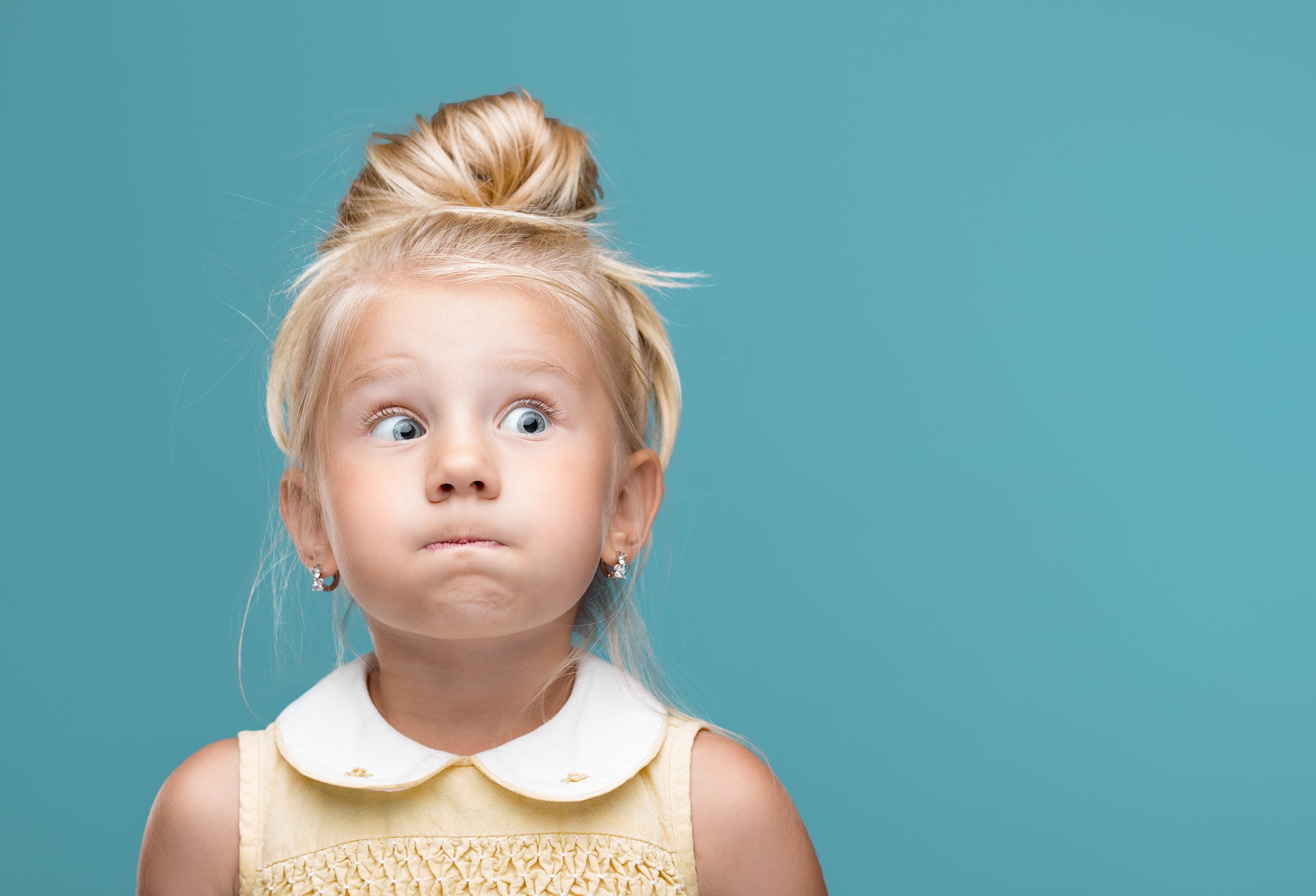 Young girl kid holding breath mouth shut blue background funny