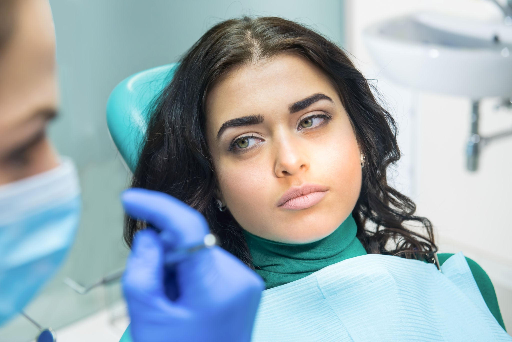 Woman-with-a-serious-face-listening-her-dentist