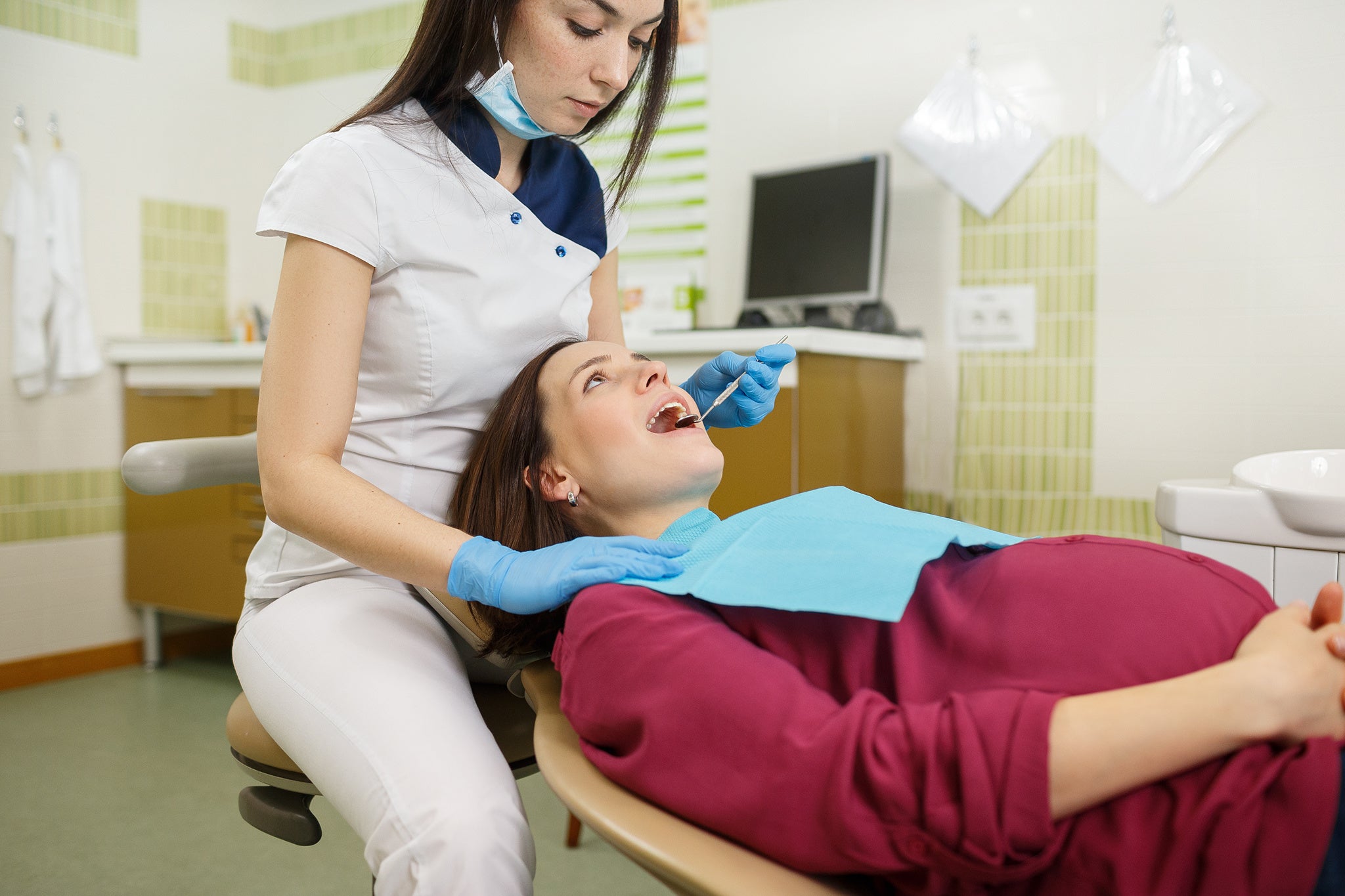 Pregnant woman female at dental clinic