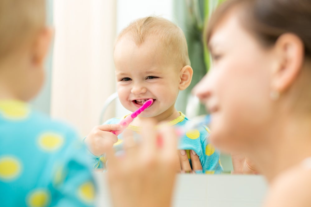 Mother-and-baby-brushing-in-mirror