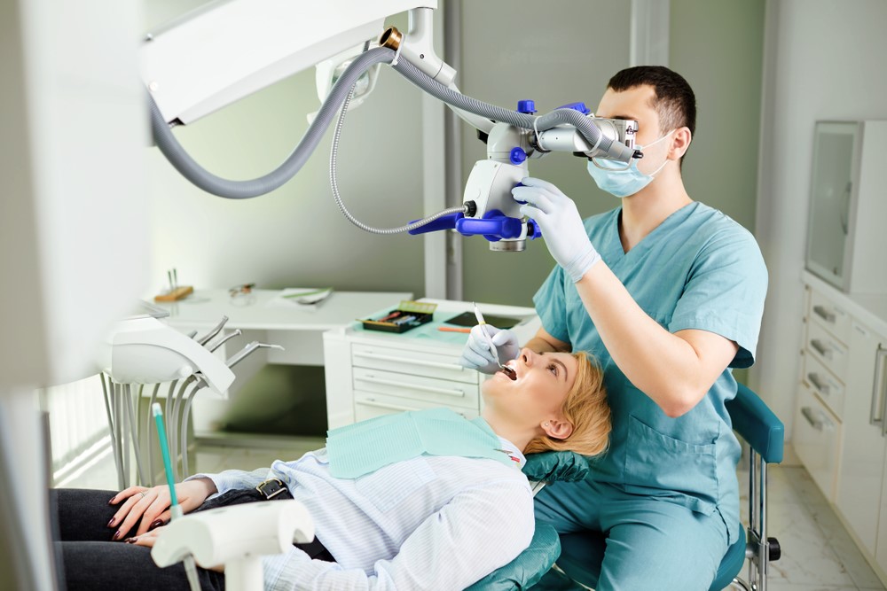 OCP-Dentist with microscope treating patient